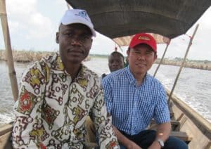 Enjoying a boat ride with Georges Late, manager of Editions PBA, in Benin.